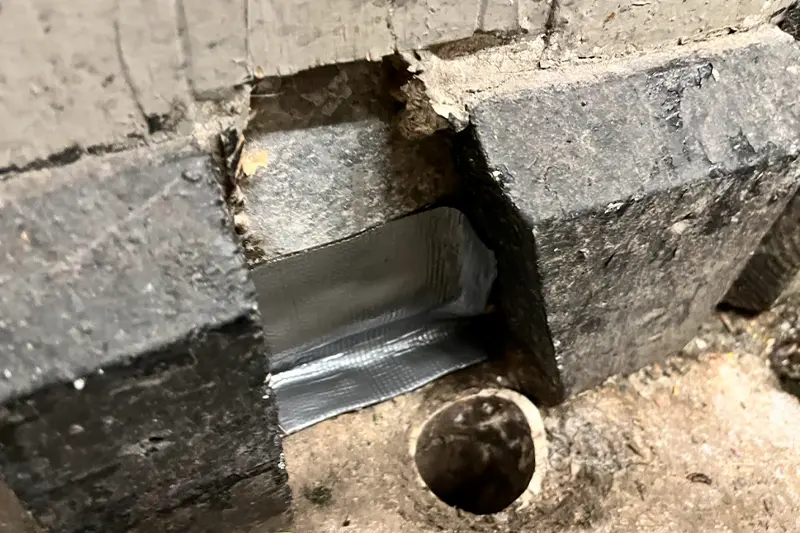 Concrete gap space in-between the stone of a wall & flooring, perfect for Live Oak Pest Controls Flexi Armour protection.