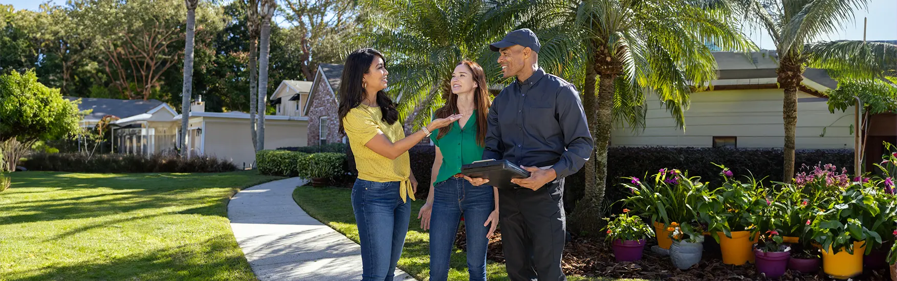 Exterminator speaking with home owners on the sidewalk | Live Oak Pest Control serving McAlpin, FL